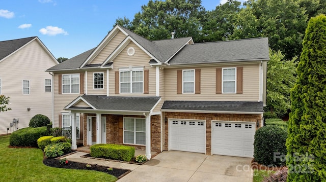 1504 Jekyll Ln, Waxhaw, NC 28173 - view of front of property featuring driveway, a garage, stone siding, roof with shingles, and a front lawn