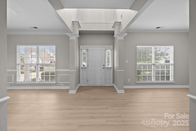 1504 Jekyll Ln, Waxhaw, NC 28173 - entryway featuring ornate columns, crown molding, light wood-style flooring, and healthy amount of natural light