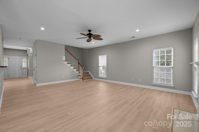 1504 Jekyll Ln, Waxhaw, NC 28173 - unfurnished living room with a ceiling fan, stairway, light wood finished floors, and recessed lighting