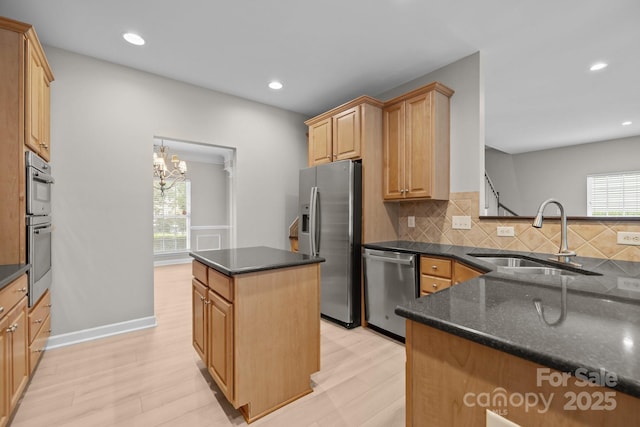 1504 Jekyll Ln, Waxhaw, NC 28173 - kitchen with appliances with stainless steel finishes, decorative backsplash, a chandelier, a kitchen island, and recessed lighting