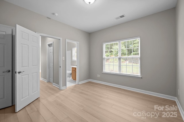 1504 Jekyll Ln, Waxhaw, NC 28173 - unfurnished bedroom featuring light wood-type flooring and ensuite bath