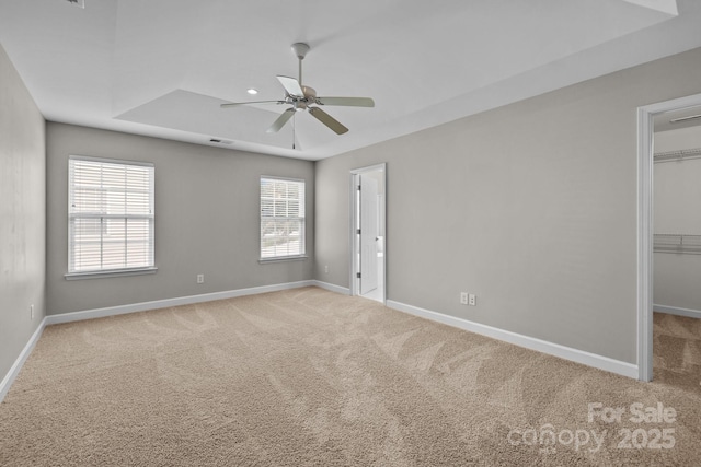1504 Jekyll Ln, Waxhaw, NC 28173 - empty room featuring carpet flooring, a ceiling fan, and a tray ceiling