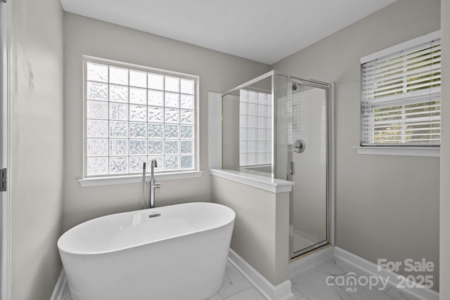 1504 Jekyll Ln, Waxhaw, NC 28173 - bathroom with plenty of natural light, a stall shower, and a freestanding tub