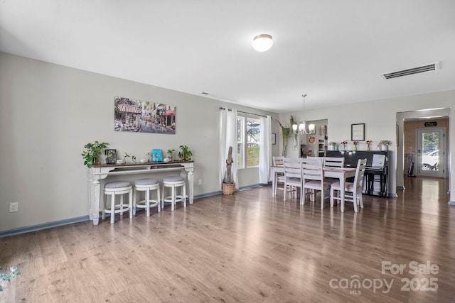 712 Coventry Dr, Albemarle, NC 28001 - dining room featuring a chandelier, wood finished floors, and healthy amount of natural light
