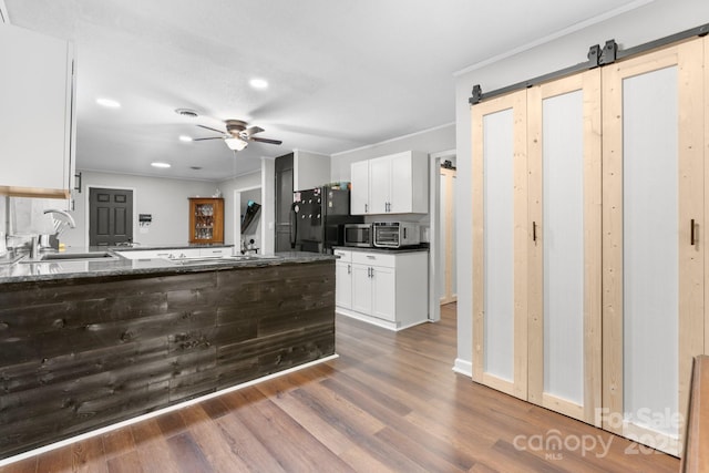 1560 Lafayette Ave, Hudson, NC 28638 - kitchen with freestanding refrigerator, white cabinets, dark wood finished floors, a ceiling fan, and stainless steel microwave