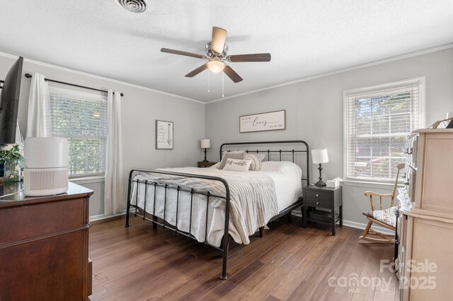 1560 Lafayette Ave, Hudson, NC 28638 - bedroom with wood finished floors, ornamental molding, multiple windows, and ceiling fan