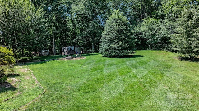1560 Lafayette Ave, Hudson, NC 28638 - view of grassy yard featuring a fire pit and an outdoor structure