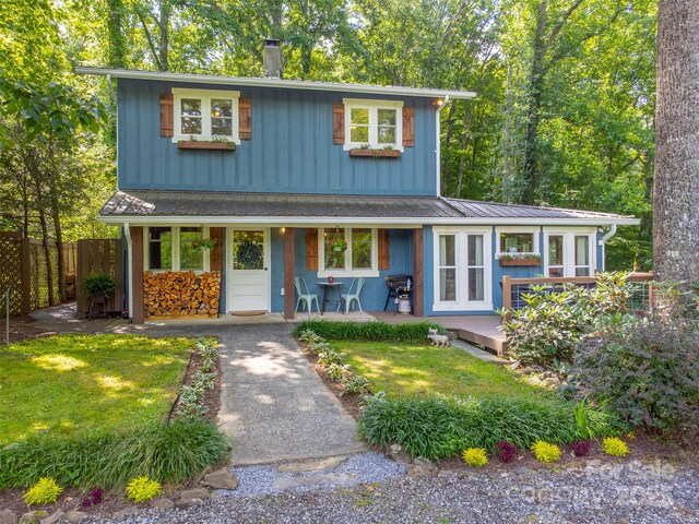 590 Claude Cook Rd, Sylva, NC 28779 - traditional-style house featuring a porch, a chimney, board and batten siding, and a metal roof