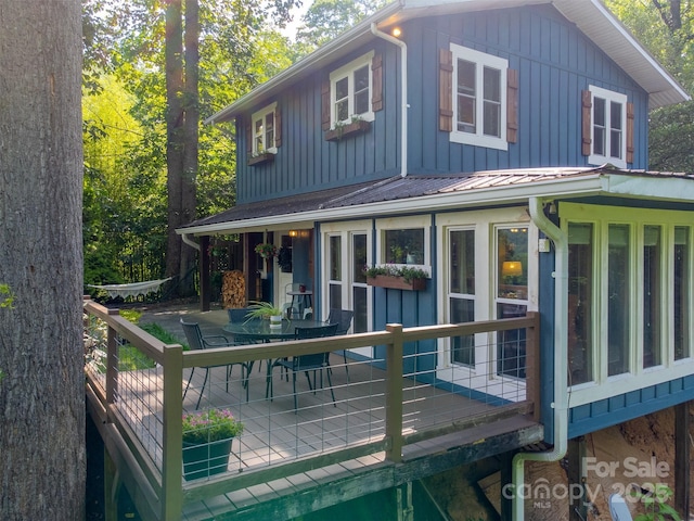 590 Claude Cook Rd, Sylva, NC 28779 - rear view of property with board and batten siding, outdoor dining area, a metal roof, and a sunroom