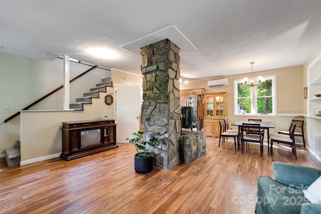 590 Claude Cook Rd, Sylva, NC 28779 - living area with a wall mounted air conditioner, stairs, wood finished floors, and a chandelier