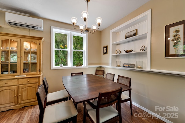 590 Claude Cook Rd, Sylva, NC 28779 - dining room featuring a wall unit AC, a chandelier, and wood finished floors