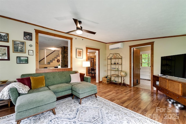 590 Claude Cook Rd, Sylva, NC 28779 - living area featuring a wall unit AC, wood finished floors, stairway, ceiling fan, and ornamental molding