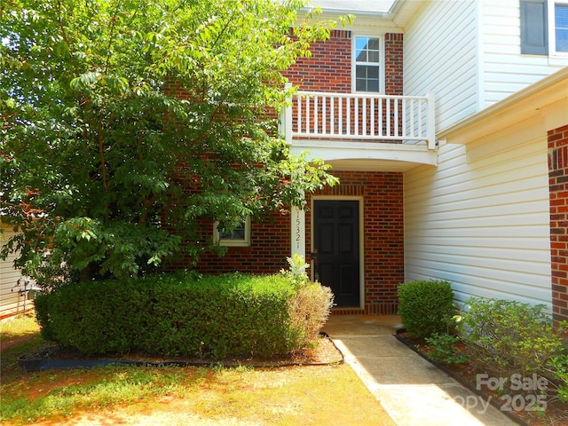 15321 Superior St, Charlotte, NC 28273 - view of exterior entry with a balcony and brick siding