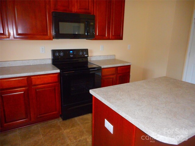 15321 Superior St, Charlotte, NC 28273 - kitchen featuring black appliances, reddish brown cabinets, light countertops, and dark tile patterned flooring