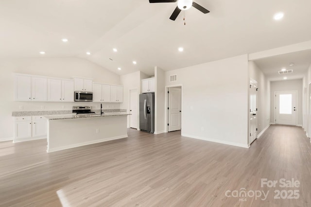 1066 Russell Dr, Winston Salem, NC 27127 - unfurnished living room featuring vaulted ceiling, light wood-style flooring, a ceiling fan, and recessed lighting