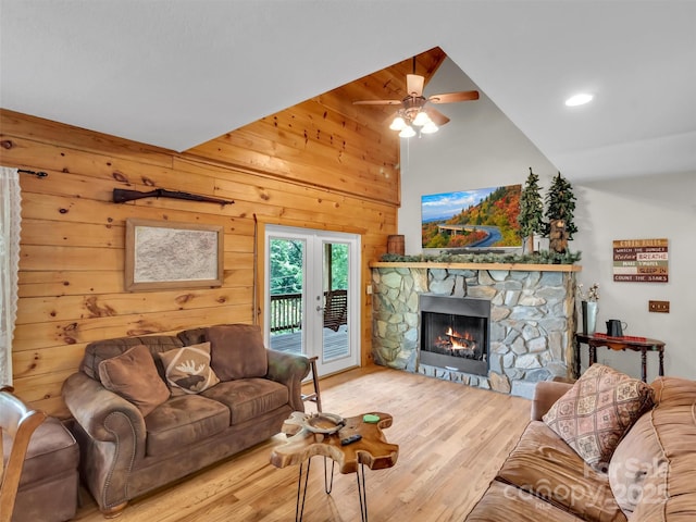 1064 Point Of View Dr, Waynesville, NC 28785 - living area with a fireplace, a ceiling fan, wood finished floors, wood walls, and high vaulted ceiling