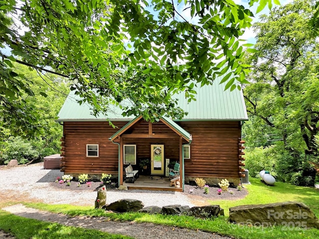 1064 Point Of View Dr, Waynesville, NC 28785 - back of house featuring a metal roof, log siding, and covered porch