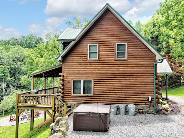 1064 Point Of View Dr, Waynesville, NC 28785 - view of home's exterior featuring a hot tub, log exterior, a deck, and a metal roof