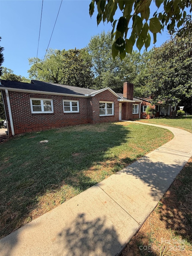 727 3rd Ave NW, Hickory, NC 28601 - ranch-style house with brick siding, a chimney, and a front lawn
