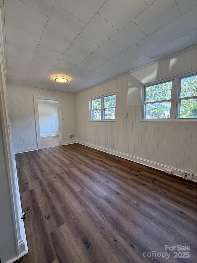 727 3rd Ave NW, Hickory, NC 28601 - unfurnished room featuring dark wood-style floors and wood walls