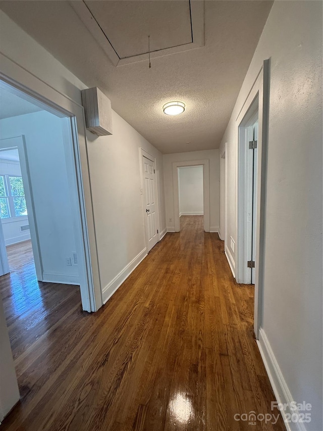727 3rd Ave NW, Hickory, NC 28601 - hall featuring attic access, dark wood finished floors, and a textured ceiling