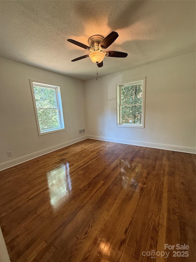 727 3rd Ave NW, Hickory, NC 28601 - spare room featuring a textured ceiling, dark wood finished floors, and ceiling fan