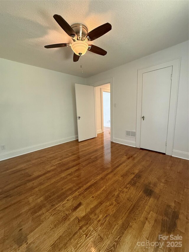 727 3rd Ave NW, Hickory, NC 28601 - unfurnished bedroom with wood finished floors, a textured ceiling, and ceiling fan