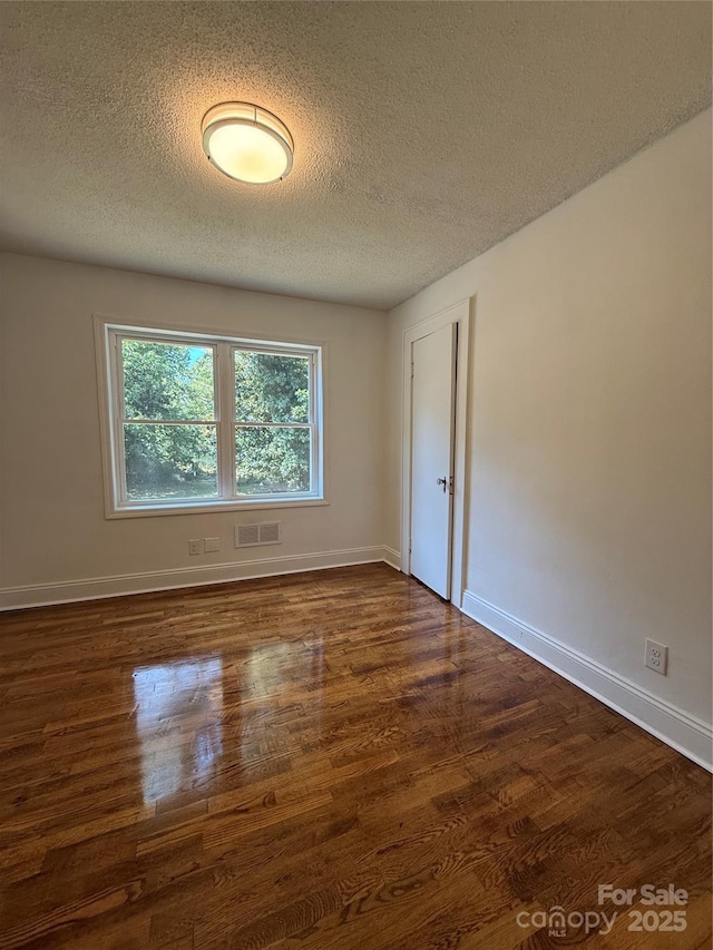 727 3rd Ave NW, Hickory, NC 28601 - unfurnished room with dark wood-type flooring and a textured ceiling