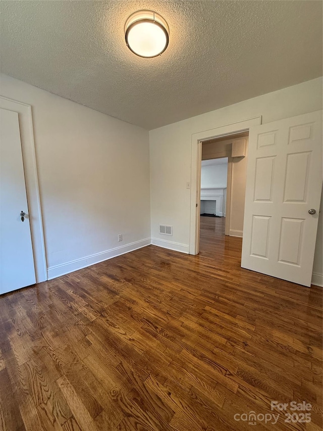 727 3rd Ave NW, Hickory, NC 28601 - unfurnished room with dark wood finished floors and a textured ceiling