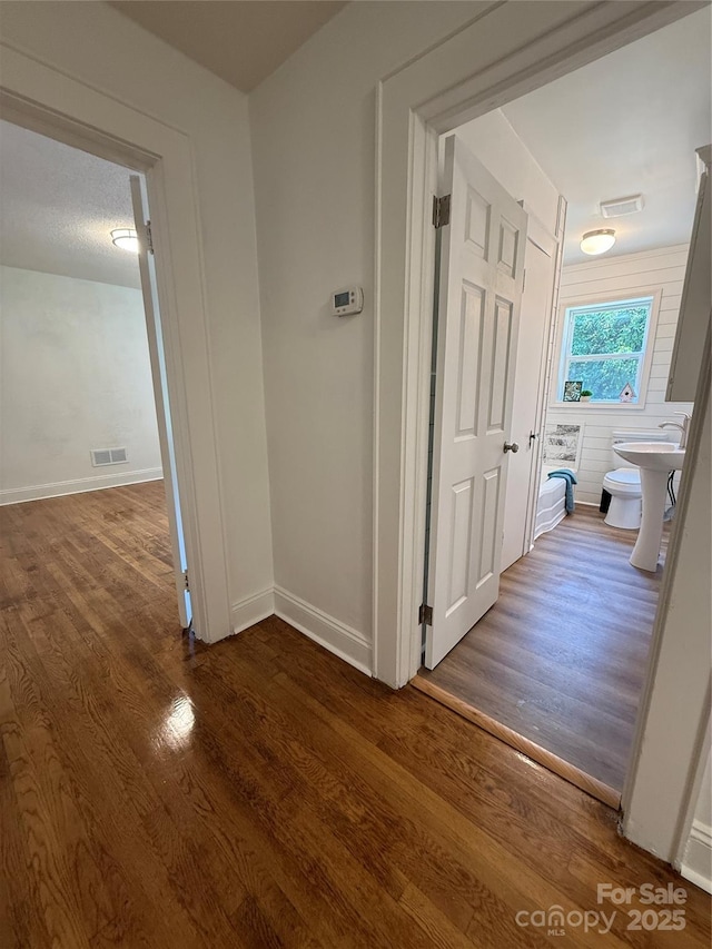 727 3rd Ave NW, Hickory, NC 28601 - hallway featuring dark wood-style flooring and baseboards