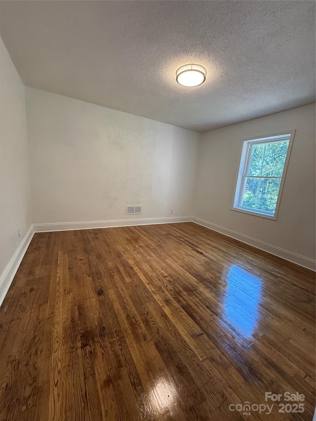 727 3rd Ave NW, Hickory, NC 28601 - spare room featuring dark wood finished floors and a textured ceiling