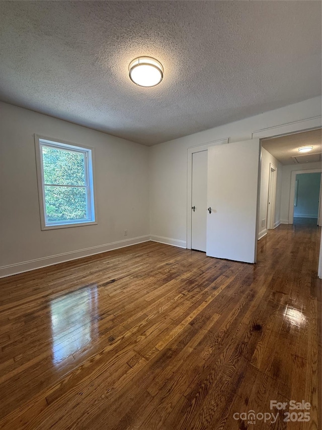 727 3rd Ave NW, Hickory, NC 28601 - empty room with wood finished floors and a textured ceiling