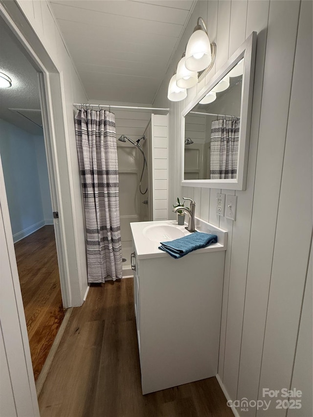 727 3rd Ave NW, Hickory, NC 28601 - full bath with wood finished floors, vanity, and curtained shower