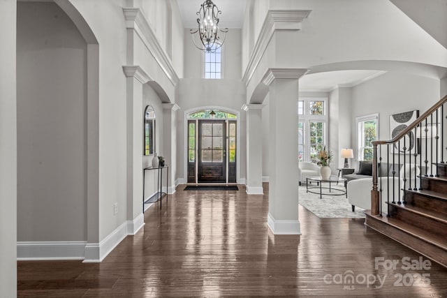 805 Hidden Pond Ln, Waxhaw, NC 28173 - foyer entrance with dark wood-style flooring, stairway, a towering ceiling, ornamental molding, and arched walkways