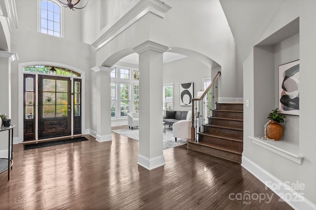 805 Hidden Pond Ln, Waxhaw, NC 28173 - foyer with decorative columns, arched walkways, wood finished floors, stairway, and a high ceiling