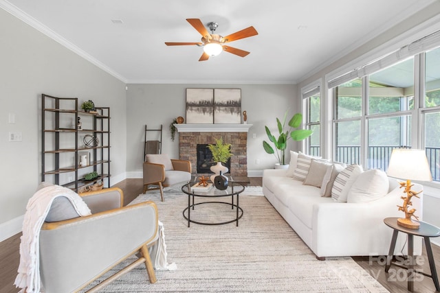 805 Hidden Pond Ln, Waxhaw, NC 28173 - living area with a ceiling fan, a stone fireplace, ornamental molding, and wood finished floors