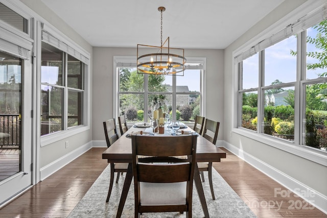805 Hidden Pond Ln, Waxhaw, NC 28173 - dining space with healthy amount of natural light, a chandelier, and dark wood finished floors