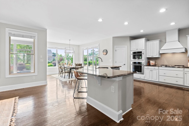 805 Hidden Pond Ln, Waxhaw, NC 28173 - kitchen with custom range hood, gas stovetop, plenty of natural light, backsplash, and recessed lighting
