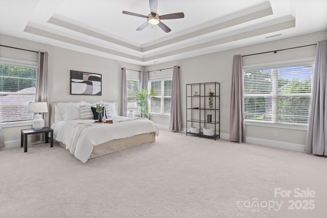 805 Hidden Pond Ln, Waxhaw, NC 28173 - bedroom with a raised ceiling, light colored carpet, multiple windows, crown molding, and ceiling fan