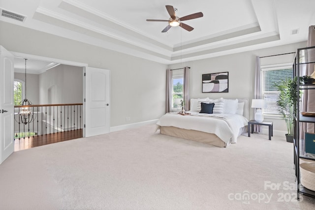 805 Hidden Pond Ln, Waxhaw, NC 28173 - bedroom with a tray ceiling, carpet, a chandelier, ornamental molding, and ceiling fan