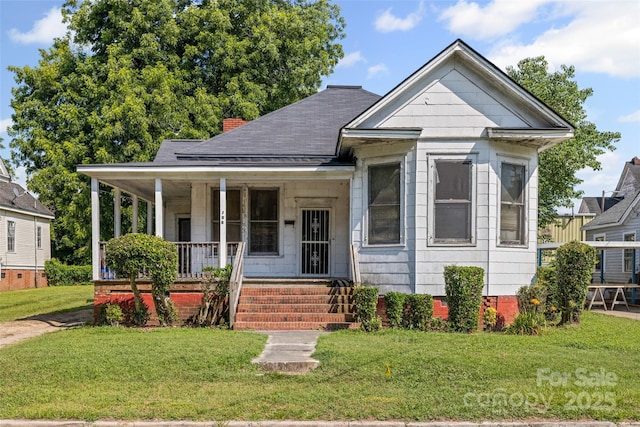 108 Walker St, Chester, SC 29706 - view of front facade featuring covered porch, a front lawn, and a chimney
