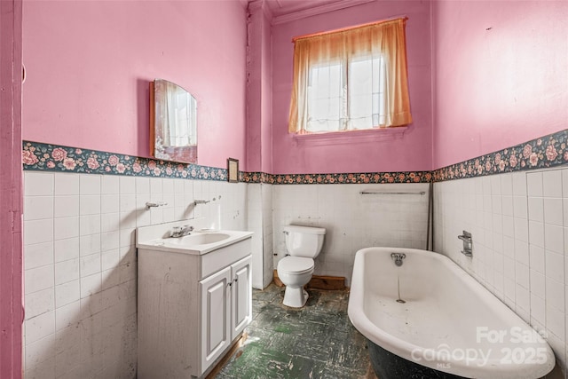108 Walker St, Chester, SC 29706 - bathroom with tile walls, a freestanding tub, wainscoting, and vanity