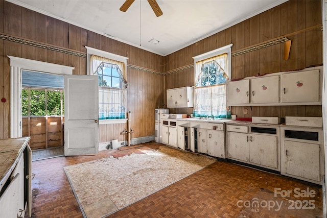 108 Walker St, Chester, SC 29706 - kitchen with wooden walls, crown molding, a ceiling fan, and tile countertops