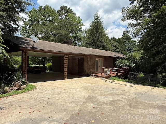 5422 River Rd, Granite Falls, NC 28630 - view of front of property with driveway, an attached carport, brick siding, a chimney, and french doors