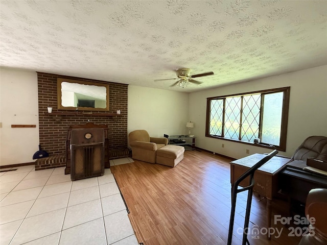 5422 River Rd, Granite Falls, NC 28630 - living area featuring a textured ceiling, a ceiling fan, and light tile patterned floors