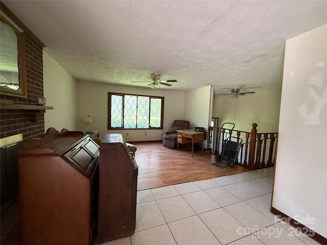 5422 River Rd, Granite Falls, NC 28630 - living room featuring ceiling fan, a textured ceiling, and light tile patterned floors
