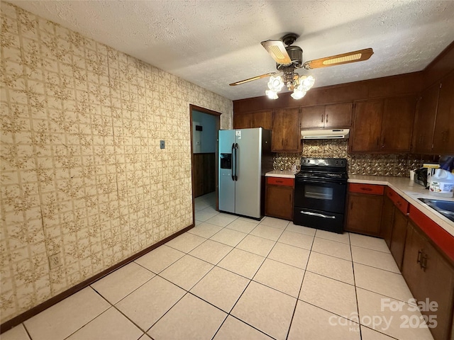 5422 River Rd, Granite Falls, NC 28630 - kitchen with black electric range, stainless steel fridge, under cabinet range hood, light countertops, and a ceiling fan