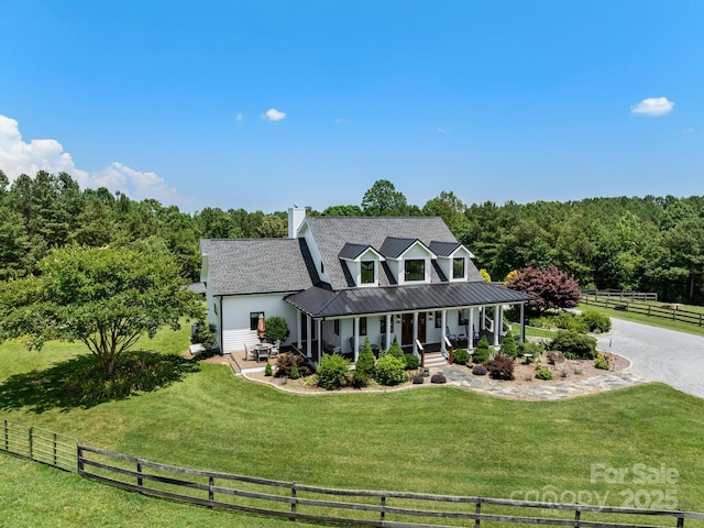 724 Moore Rd, Tryon, NC 28782 - view of front of house featuring a porch, a chimney, a metal roof, driveway, and a standing seam roof