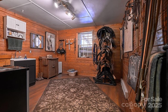 724 Moore Rd, Tryon, NC 28782 - kitchen with wood walls, wood finished floors, white cabinets, and radiator heating unit