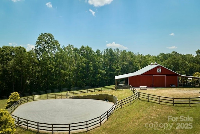 724 Moore Rd, Tryon, NC 28782 - view of yard with an outbuilding, an exterior structure, an outdoor riding arena, a wooded view, and a barn